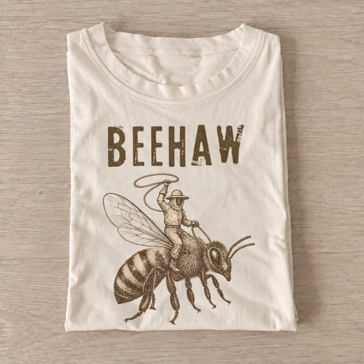 Beehaw cowboy riding bee t shirt sand20beehaw.webp