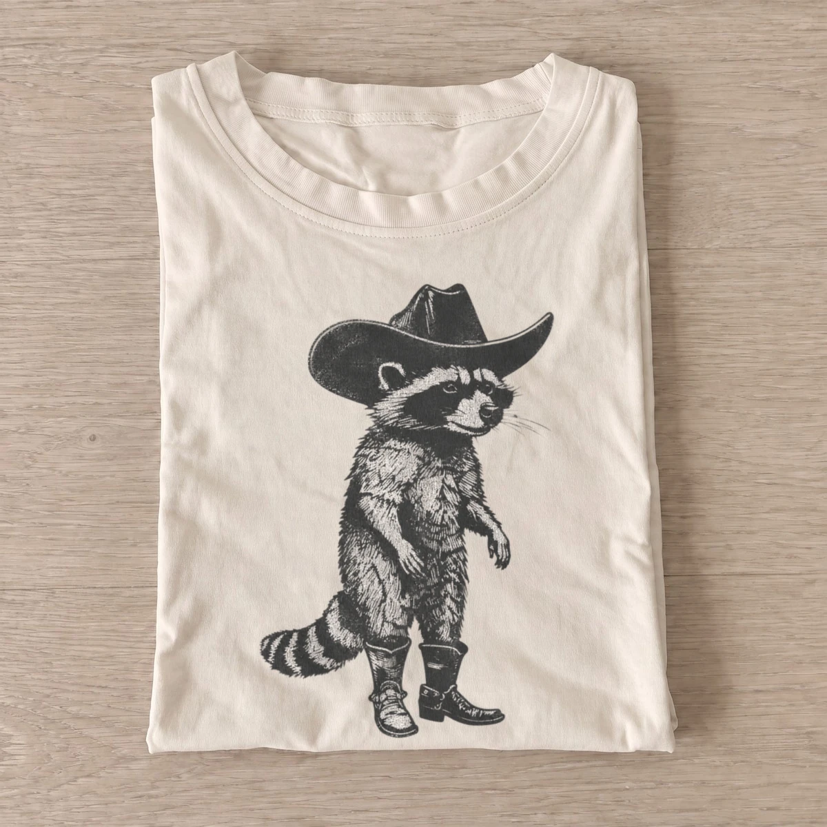 Cowboy raccoon strut t shirt sand20cowboy raccoon strut.webp