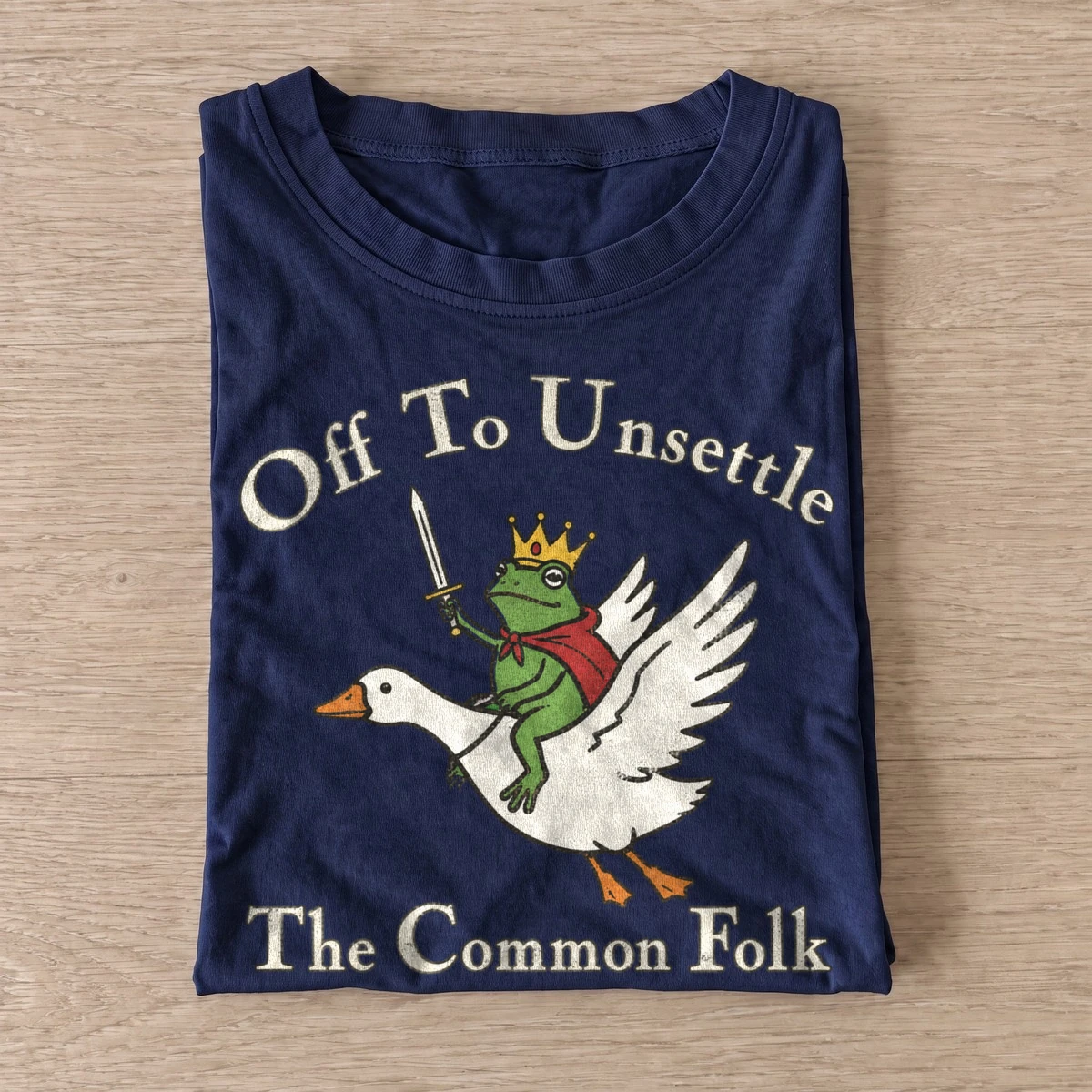 Frog king goose rider off to unsettle t shirt navy20frog king goose rider.webp