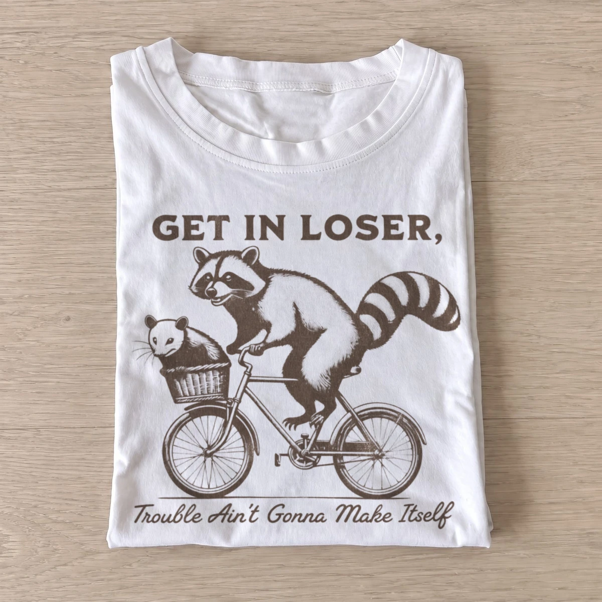 Get in loser trouble bicycle raccoon t shirt white20trouble bicycle raccoons.webp