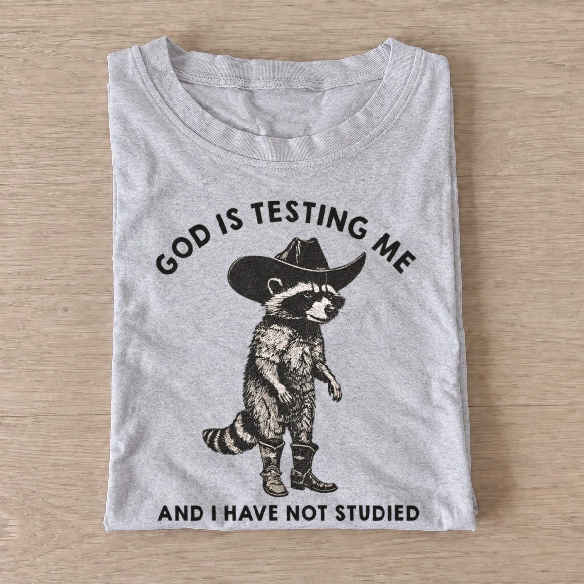 God is testing me cowboy raccoon t shirt gray20god tests raccoon.webp