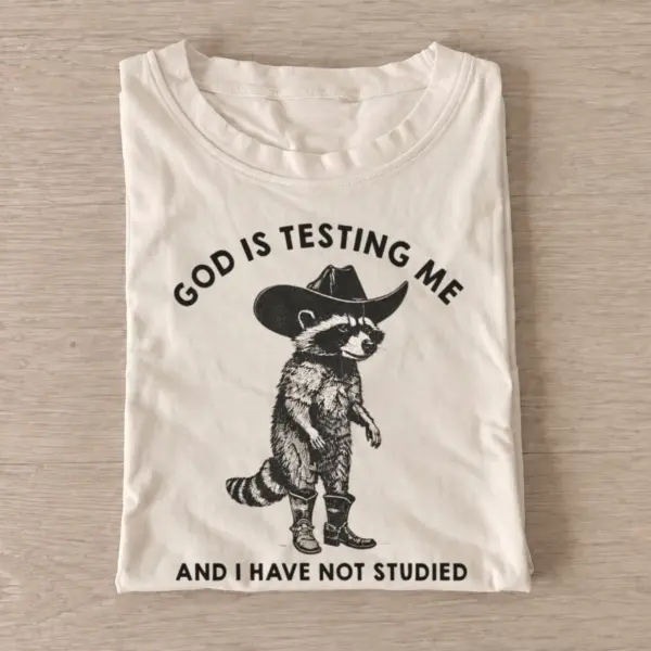 God is testing me cowboy raccoon t shirt sand20god tests raccoon.webp