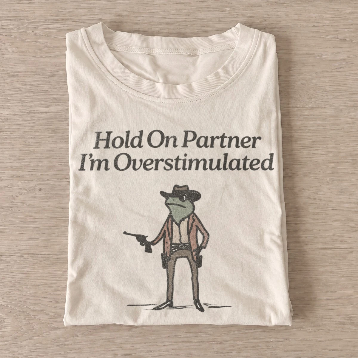 Hold on partner im overstimulated cowboy frog t shirt sand20overstimulated cowboy frog.webp