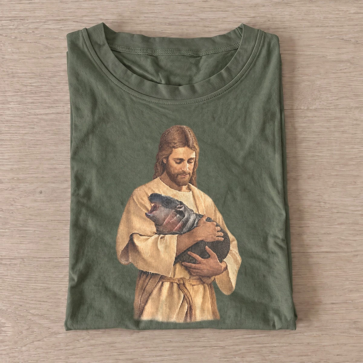 Jesus holding baby hippo t shirt olive20jesus and hippo.webp