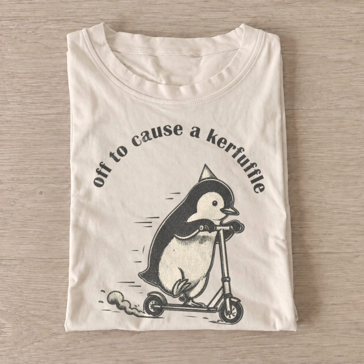 Off to cause a kerfuffle scooter penguin t shirt sand20kerfuffle scooter penguin.webp