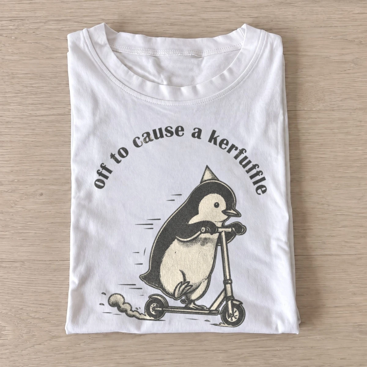 Off to cause a kerfuffle scooter penguin t shirt white20kerfuffle scooter penguin.webp