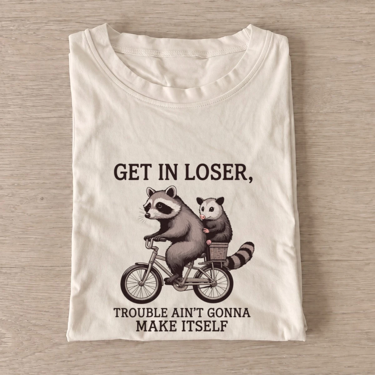 Raccoon opossum bicycle t shirt sand20raccoon opossum bicycle.webp