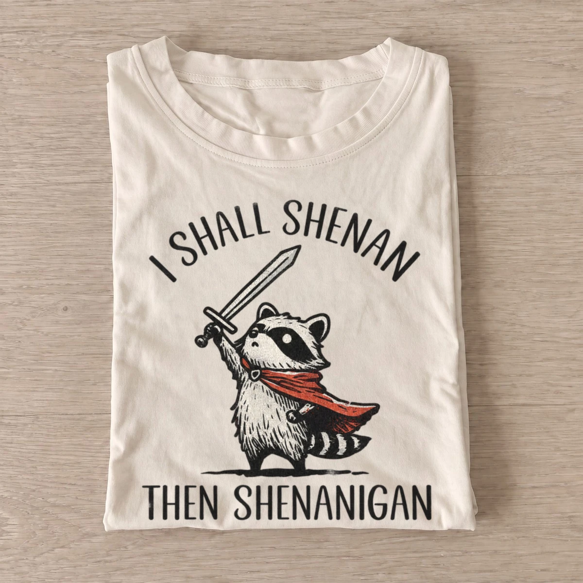 Shenanigan raccoon knight t shirt sand20shenanigan raccoon knight.webp