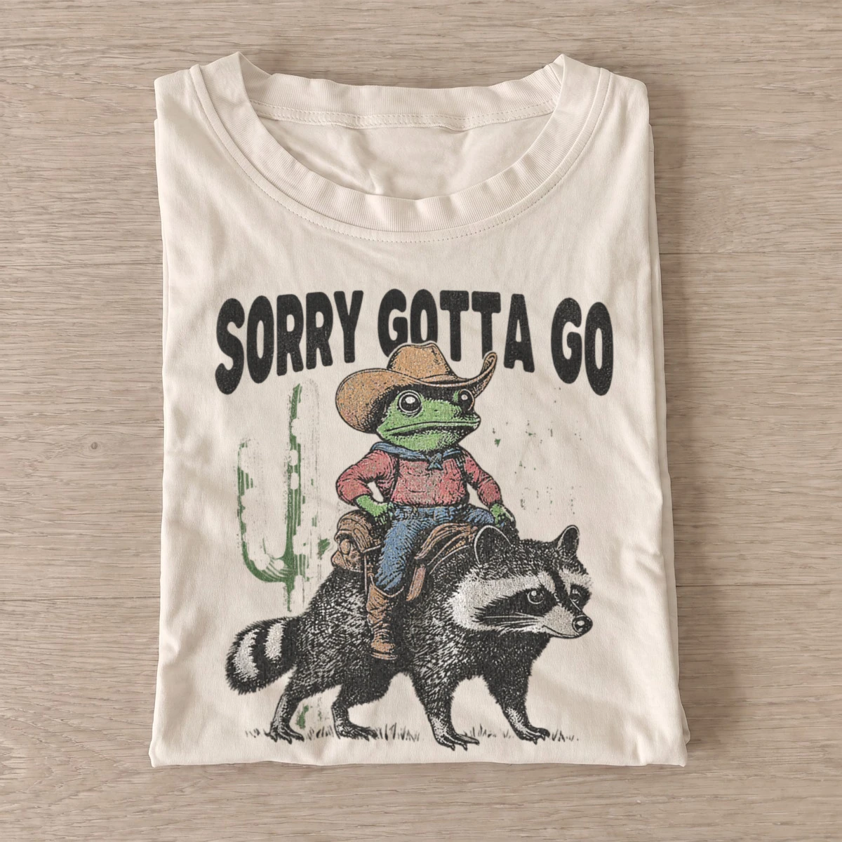 Sorry gotta go cowboy frog raccoon t shirt sand20cowboy frog raccoon.webp
