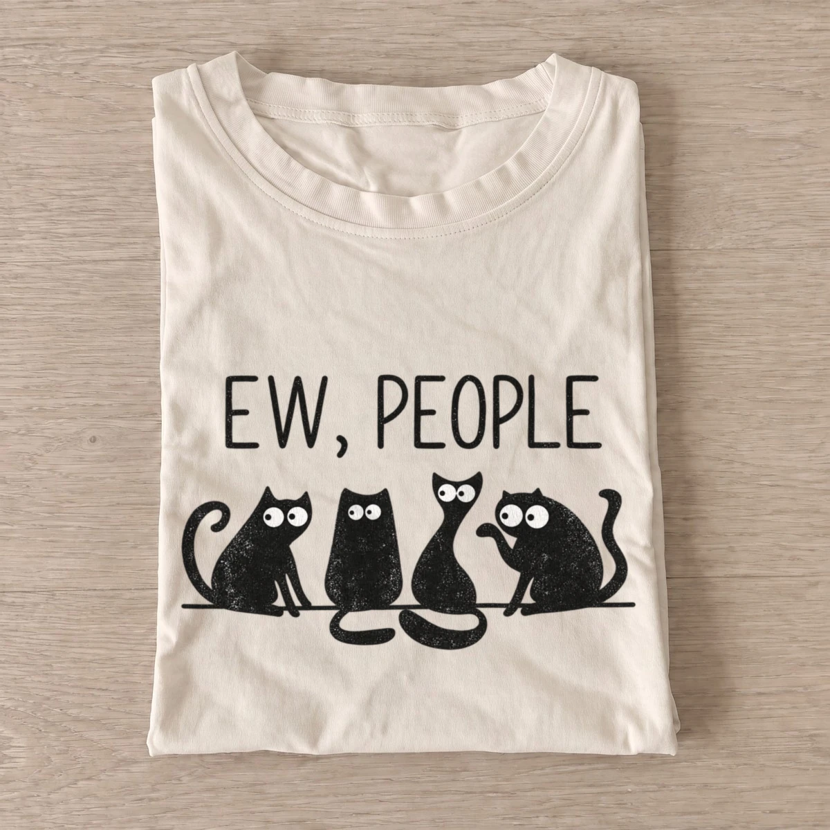 Sand Ew People Cat Squad T-shirt with three wide-eyed cats beneath EW, PEOPLE lettering